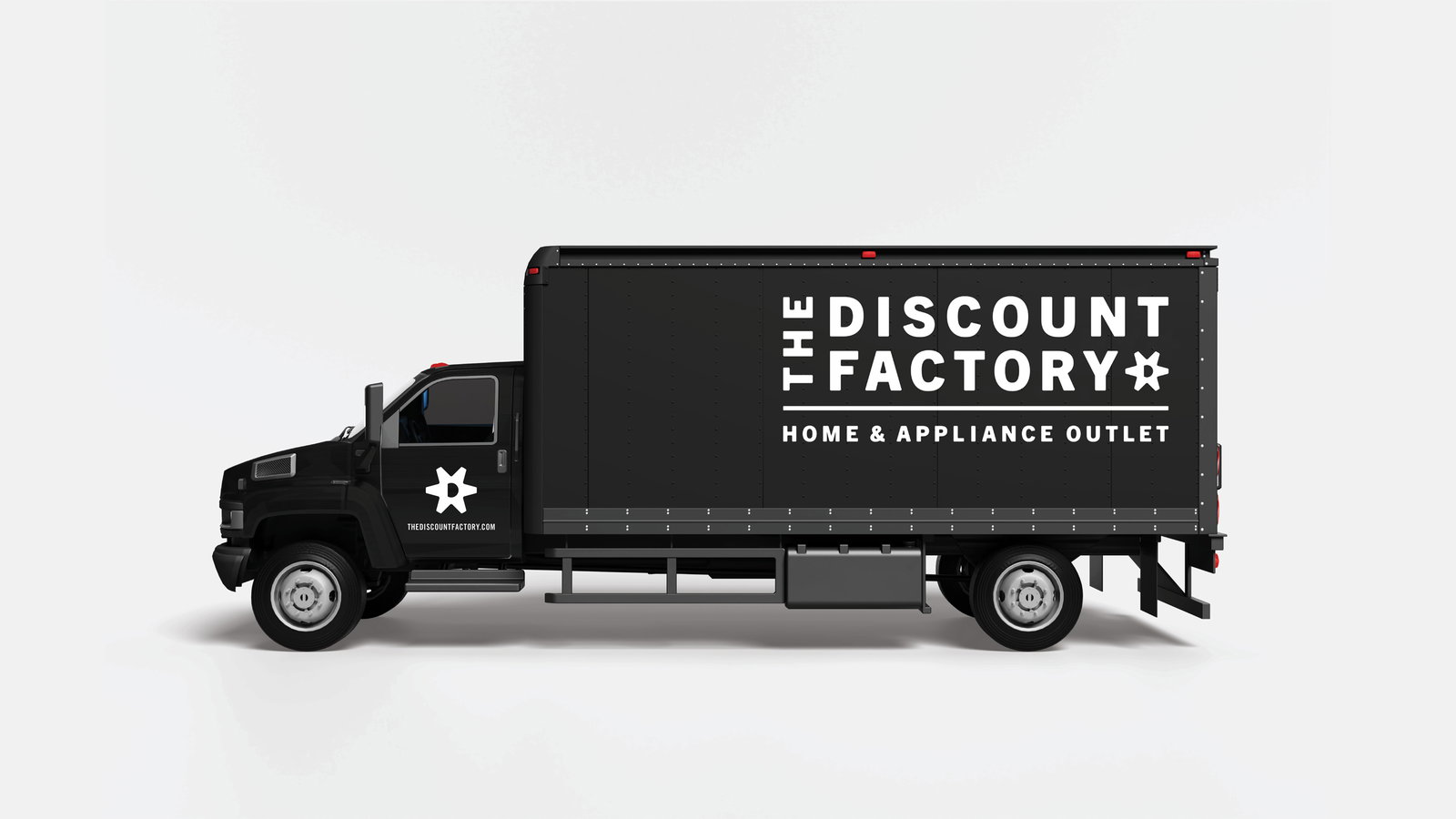 A black delivery truck with "The Discount Factory" and "Home & Appliance Outlet" in bold white text is parked against a plain light gray background.