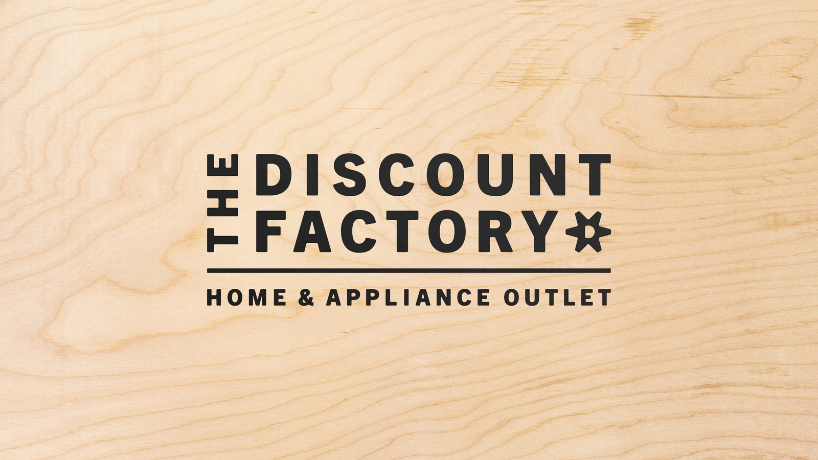 The Discount Factory Home & Appliance Outlet logo in black on a light tan woodgrain texture