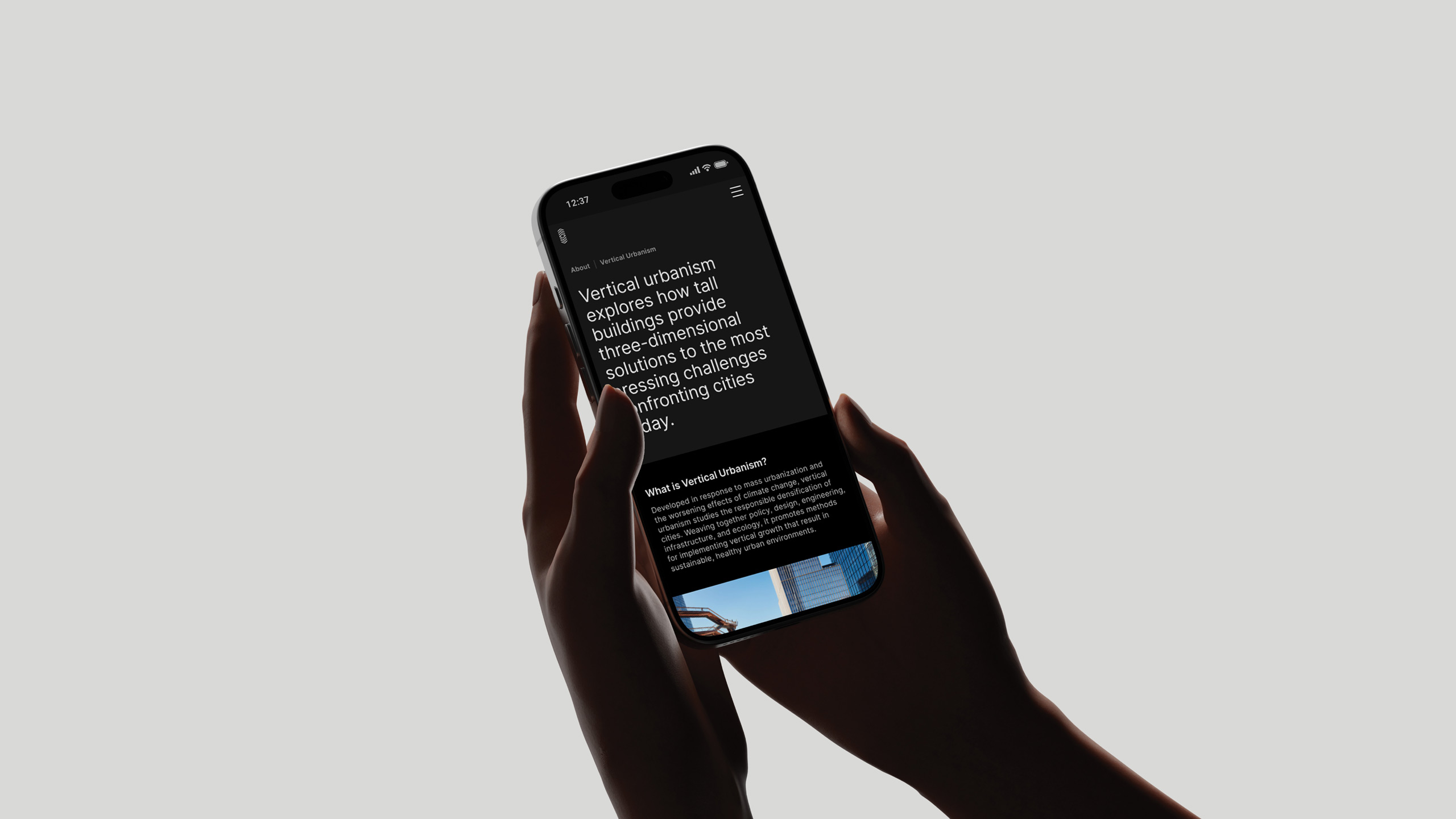 A person holds a smartphone with a black screen displaying text the about section on the Council for Vertical Urbanism website, highlighting tall buildings as solutions for city challenges.