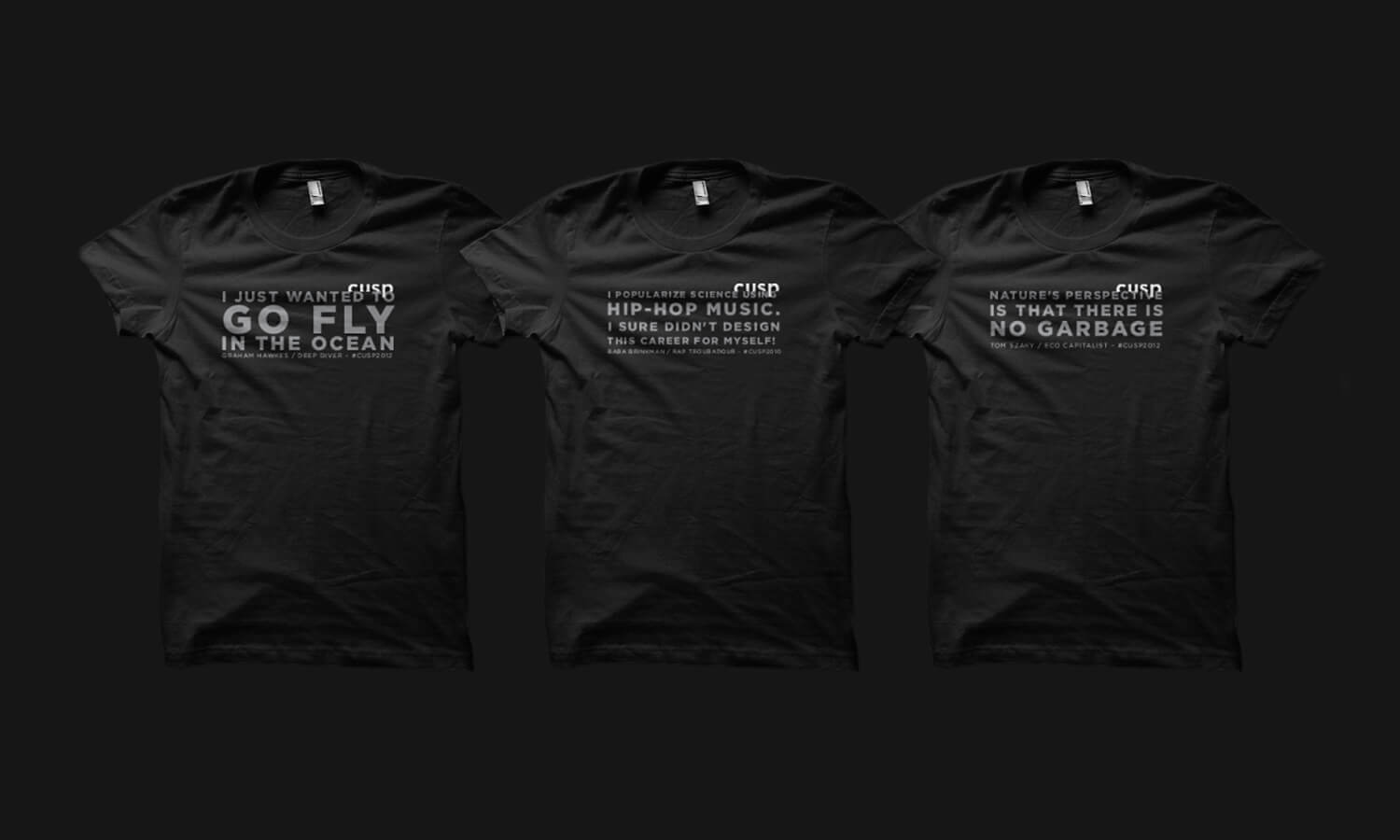 Three black t-shirts with white text on each. The shirts feature the Cusp logo in white and humorous phrases related to ocean, hip-hop music, and garbage.