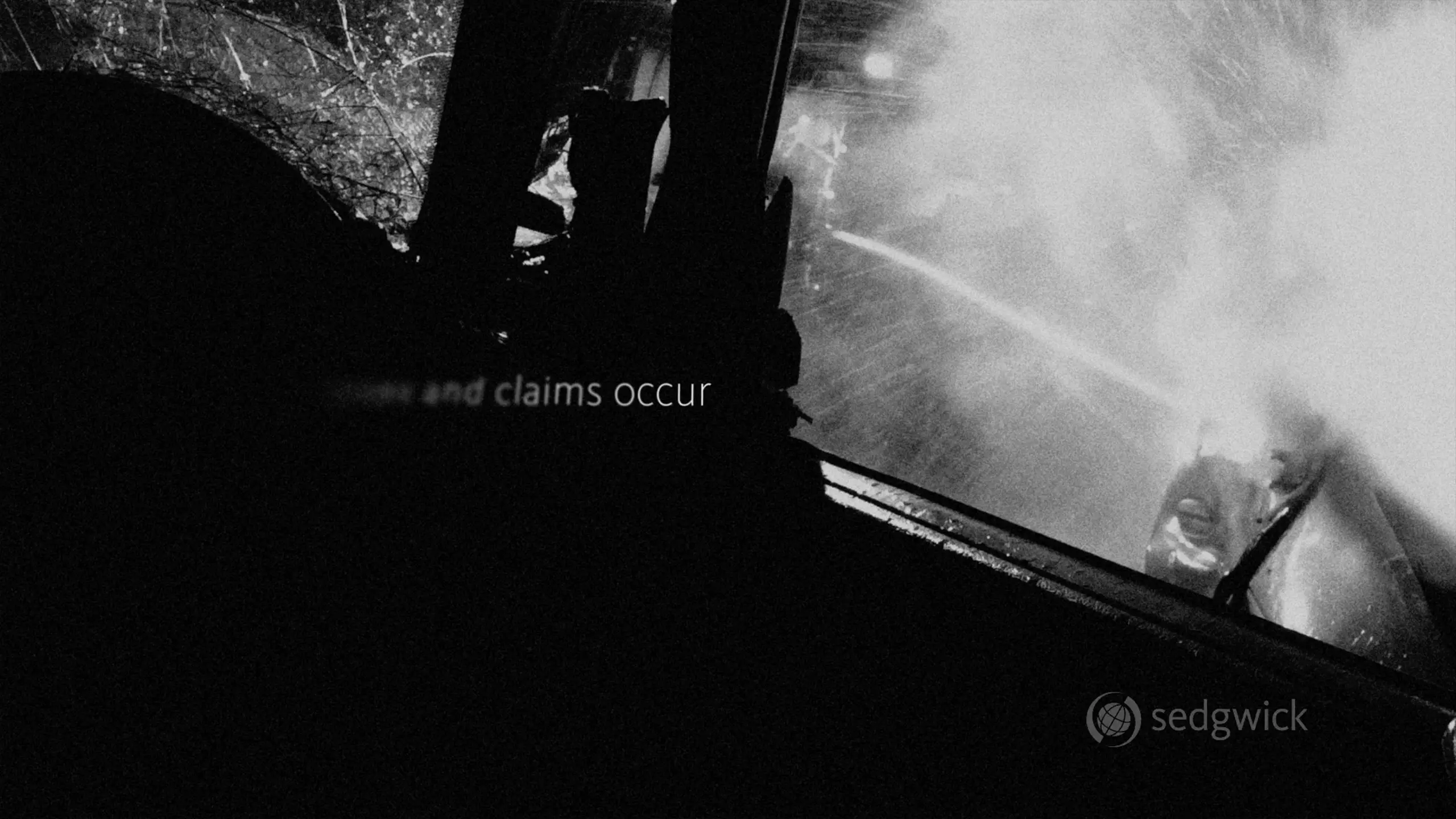 Black and white image depicting a car accident scene. A shattered windshield and smoke are visible, conveying a chaotic and intense atmosphere. Text overlays read 'claims occur' and 'sedgwick' in the bottom corner.