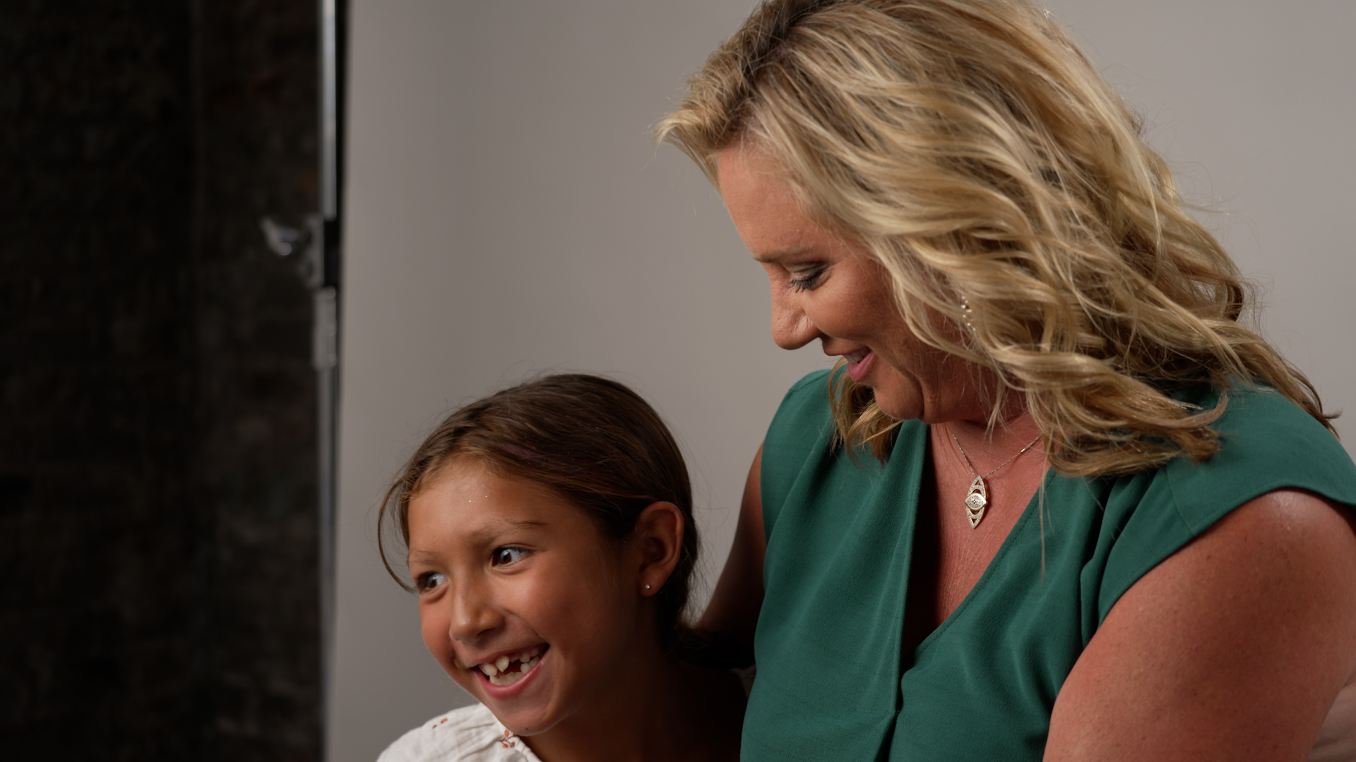 Behind the scenes photo of a woman with her daughter being interviewed about her fertility journey.