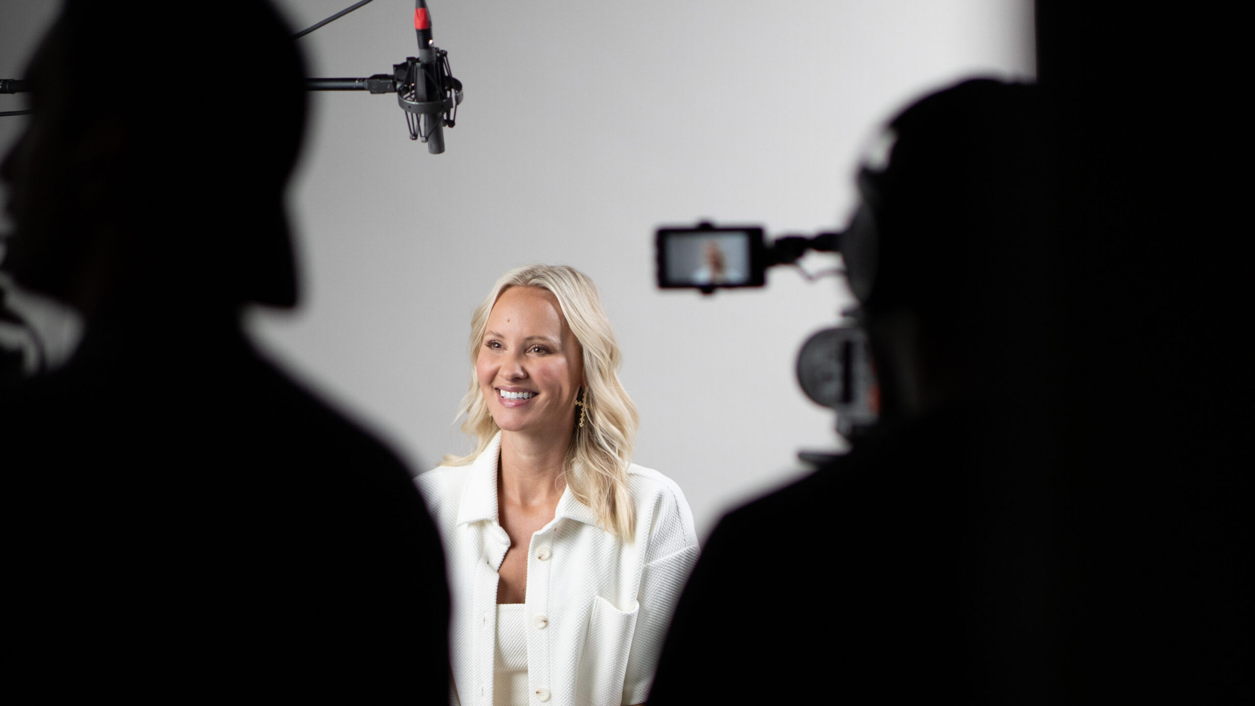 Behind the scenes photo of a woman being interviewed about her fertility journey.