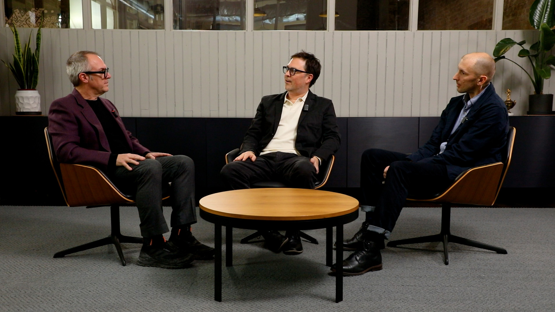 Three people discuss the brand transformation of the Council on Vertical Urbanism.