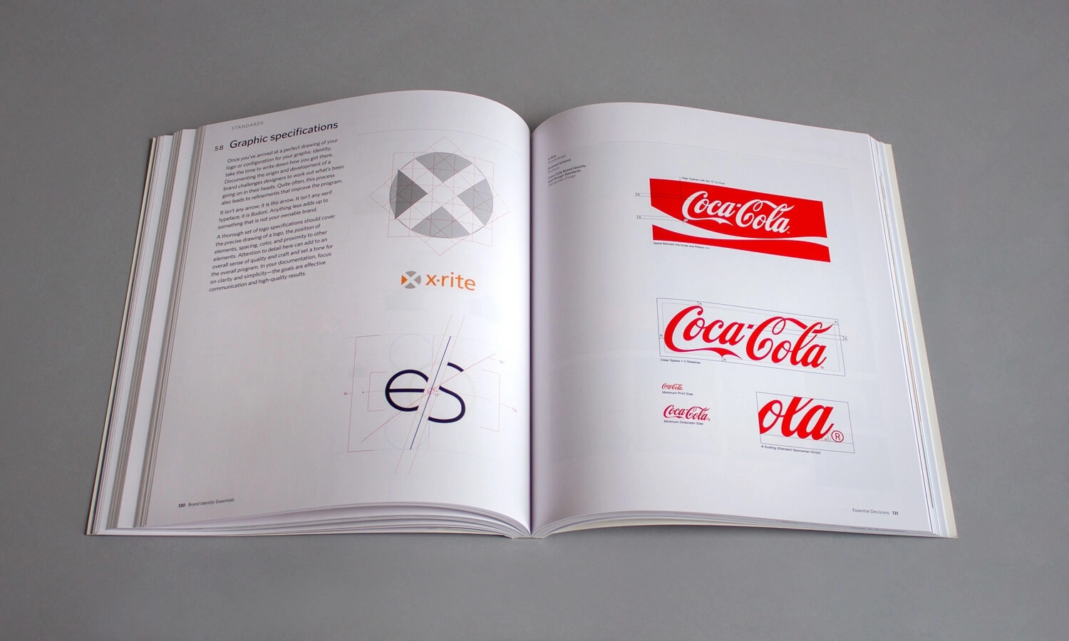Open book displaying graphic design specifications. Left page features diagrams and text; right page shows various Coca-Cola logo designs on a white background.