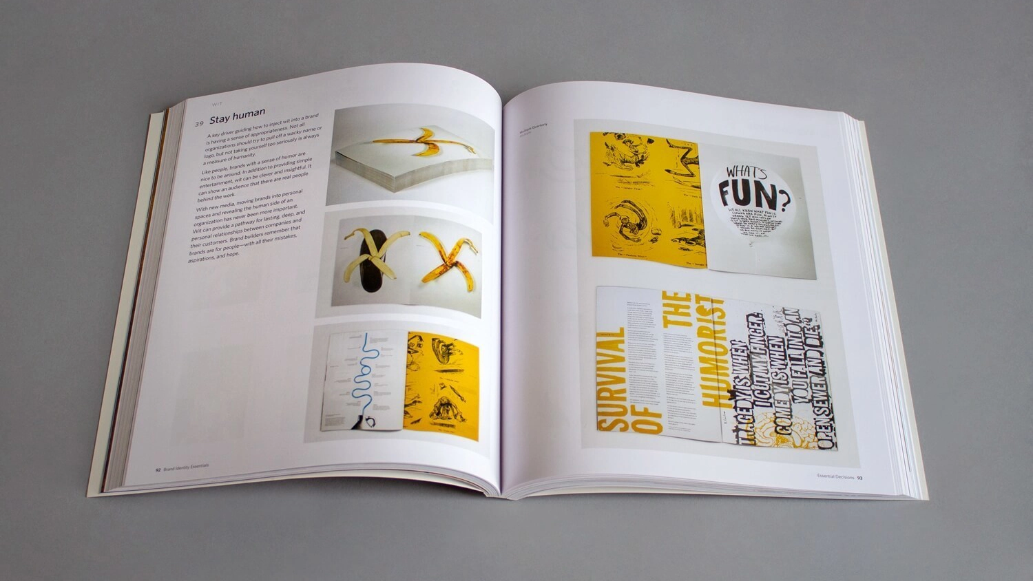 Open book displaying artistic page layouts. Left page shows banana-themed designs with text, right page features yellow graphics and bold typography.