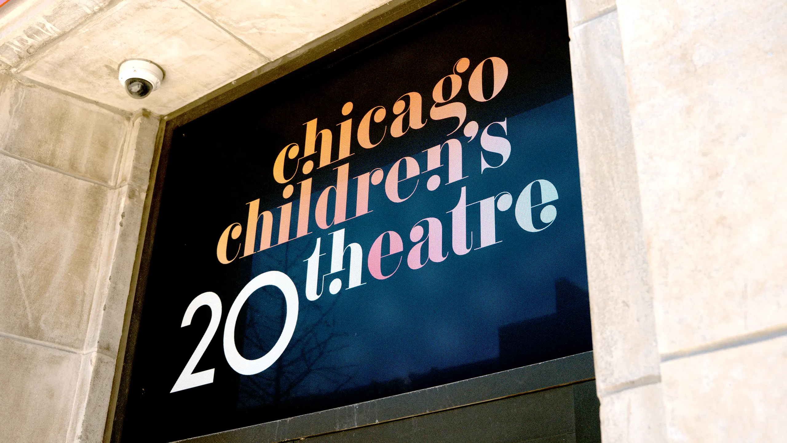 Sign for "Chicago Children's Theatre" above the venue's entrance with vibrant, colorful letters on a dark background.